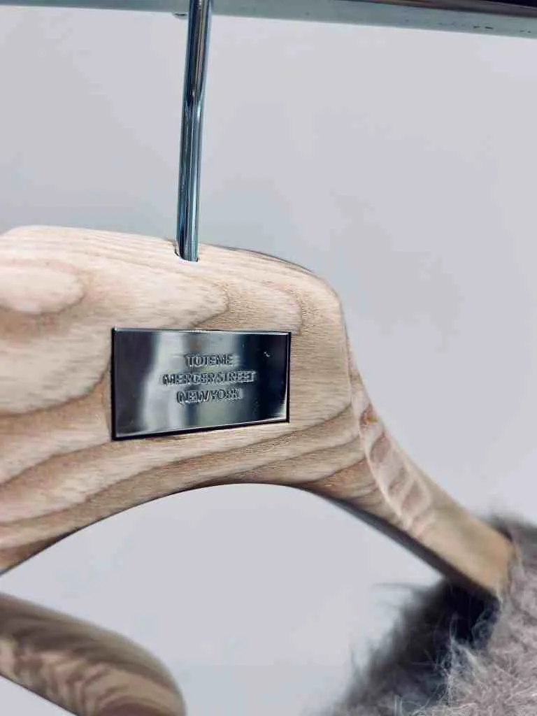 Wood hanger with brand tag on it