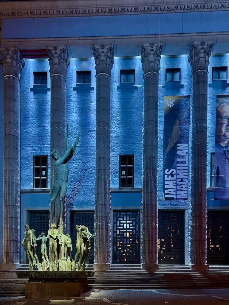 Stockholm Concert Hall by Ivar Tengom seen at night with Carl Milles sculptures