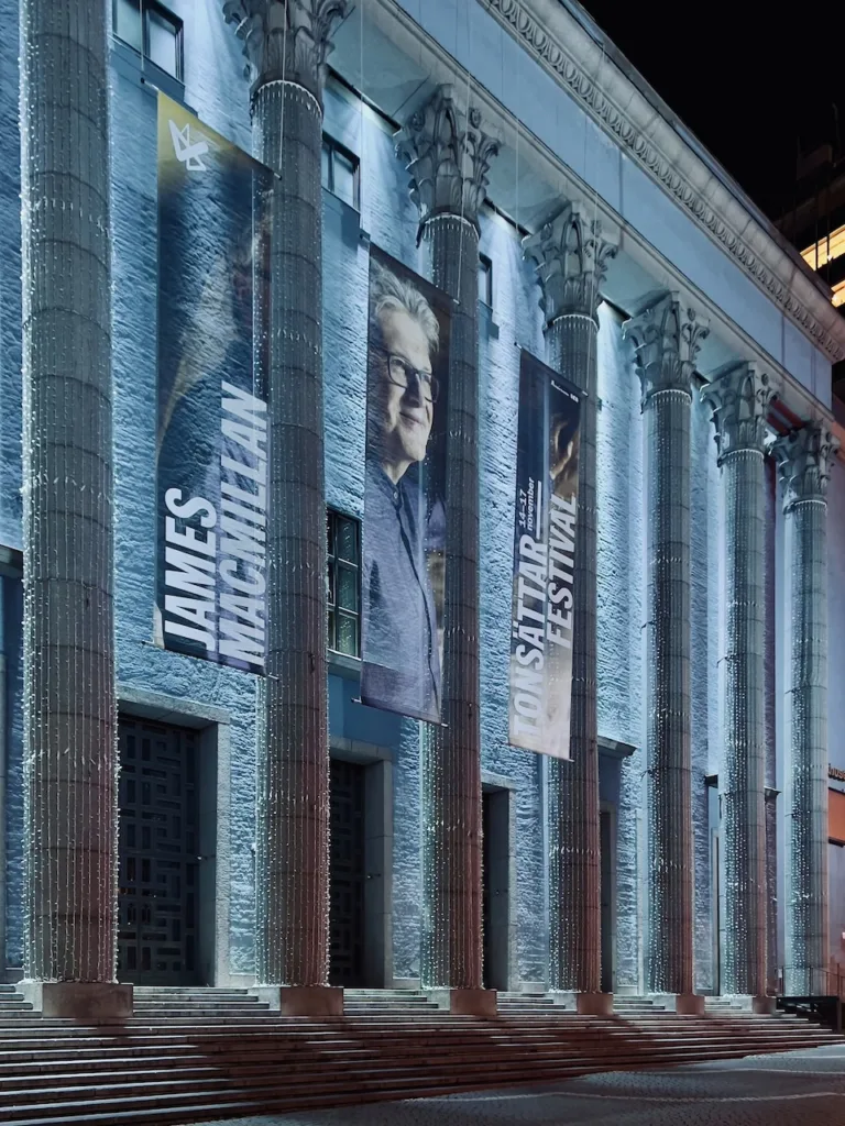 Columns of Stockholm Concert Hall seen at night with main entrance